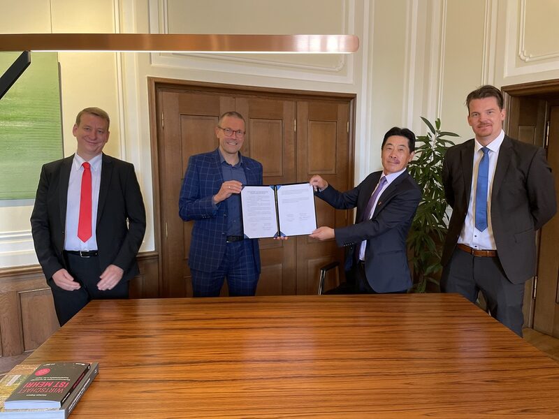 Christian Baierl, Oberbürgermeister Uwe Schneidewind, Tao Jiang und Hanno Rademacher präsentieren das unterschriebene Abkommen zur zukünftigen Kooperation mit China bei Klimaschutz-Themen.